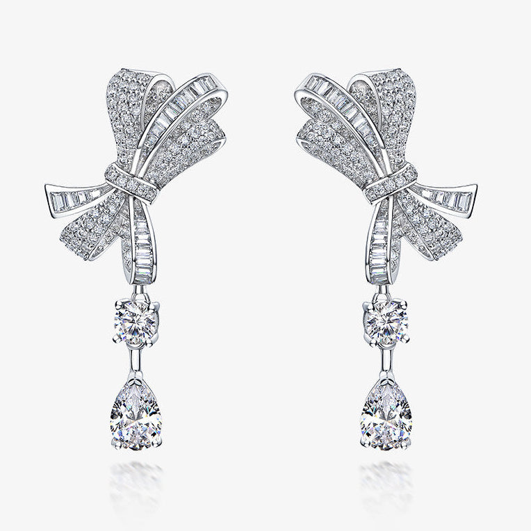 Bow-shaped earrings with teardrop designs on a white background, featuring the Shipei Jewelry brand.