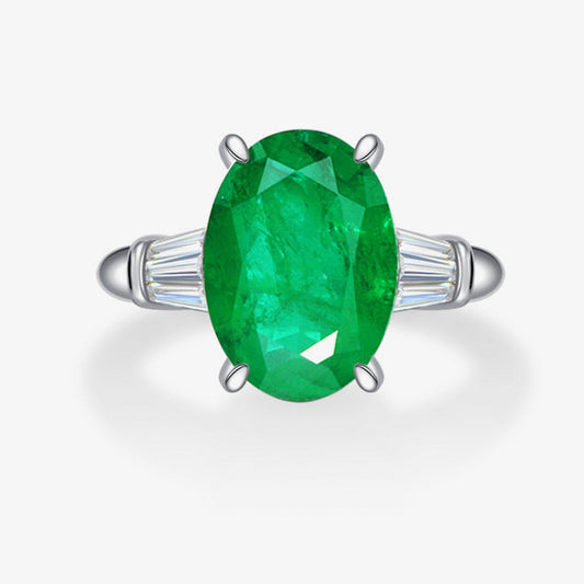 Green gemstone ring with silver setting on a white background, featuring the Shipei Jewelry logo.