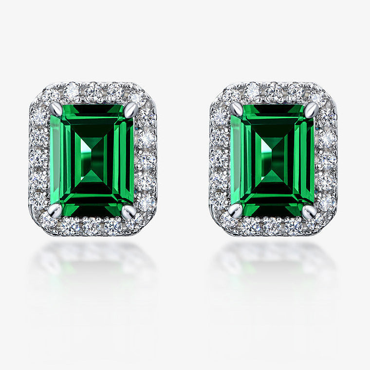 Pair of emerald green gemstone earrings with silver frames on a white background, featuring the SHIPEI JEWELRY brand.