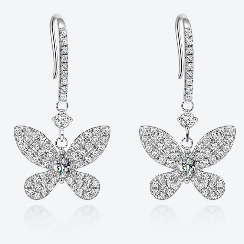 Butterfly-shaped earrings with sparkling stones on a white background, featuring the Shipe Jewelry logo.
