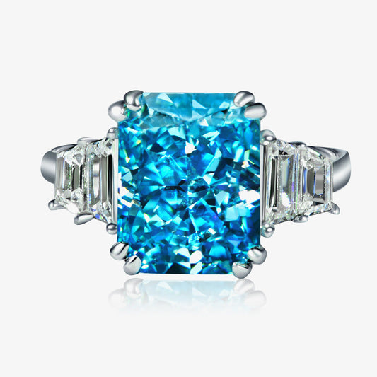 Blue gemstone ring with silver setting on a white background, featuring the Shipei Jewelry logo.