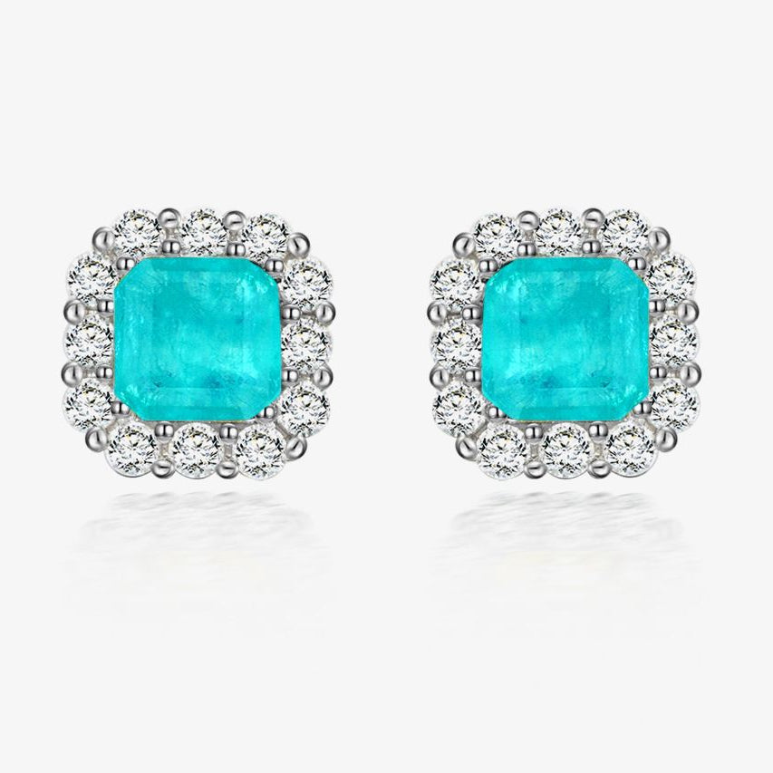 Turquoise gemstone earrings with silver surround on a white background, featuring the Shipei Jewelry logo.