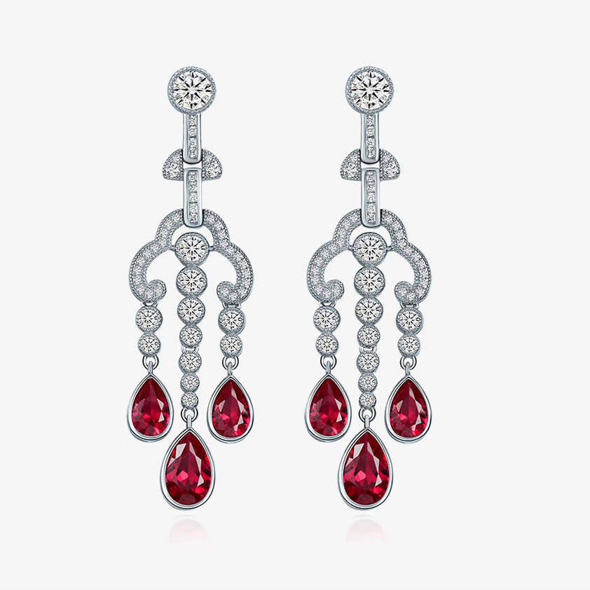 Silver earrings with red gemstones on a white background, featuring the Shipei Jewelry logo.