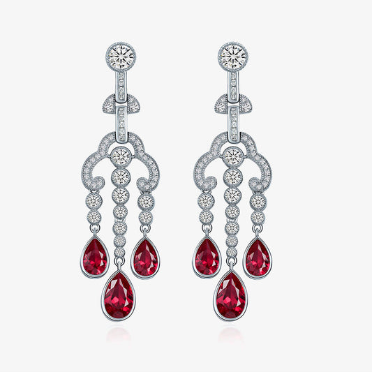Silver earrings with red gemstones on a white background, featuring the Shipei Jewelry logo.